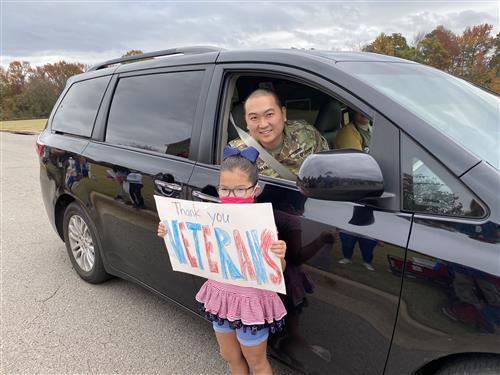 Veteran posing with his daughter in parade 